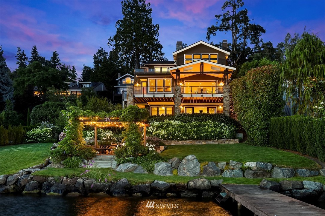 8149 West Mercer Way Mercer Island, WA 98040 - Photo 1 of 25 a front view of a house with a yard and potted plants