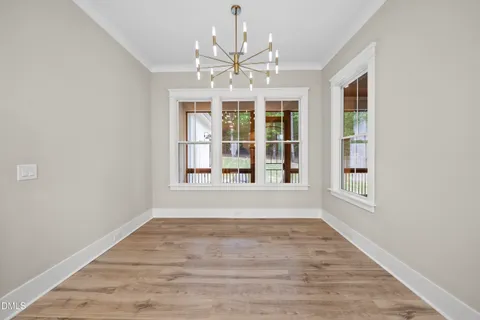 a kitchen with white cabinets and a window