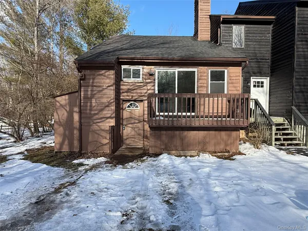 a view of a house with wooden fence