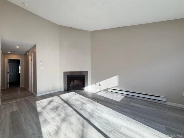 a view of an empty room and fire place