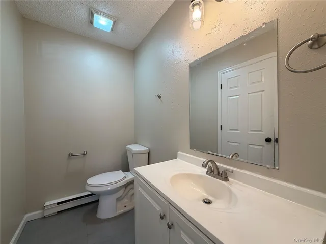 a bathroom with a sink mirror and toilet