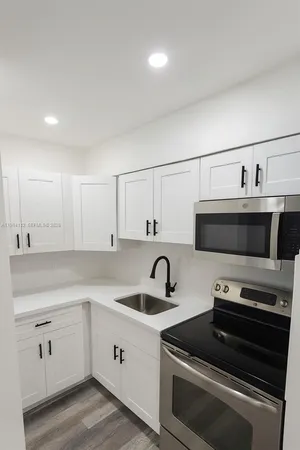 a kitchen with a sink and a stove top oven