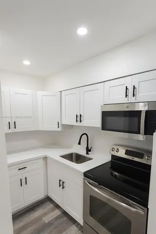a kitchen with a sink and a stove top oven