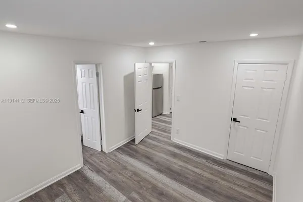 a view of hallway with wooden floor