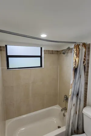 a bathroom with a shower and a toilet