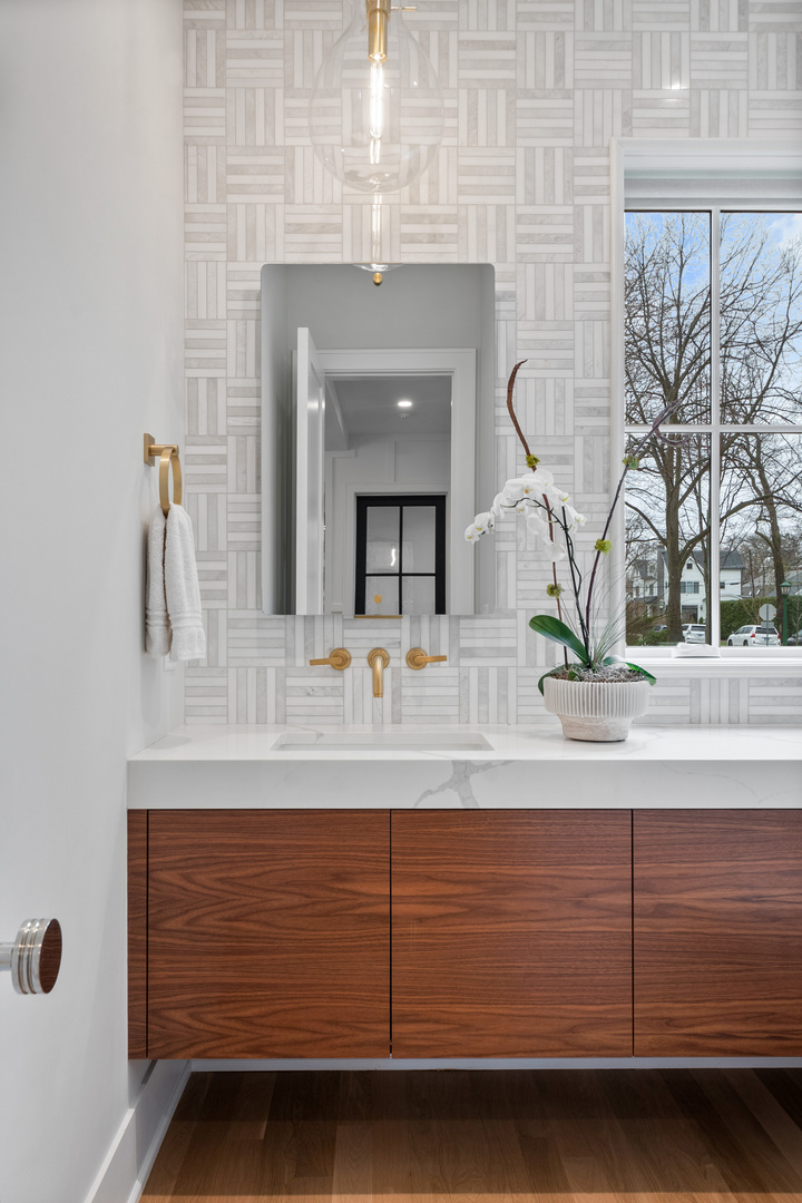 1151 Seneca Road Wilmette, IL 60091 - Photo 27 of 39 a bathroom with a sink and a mirror