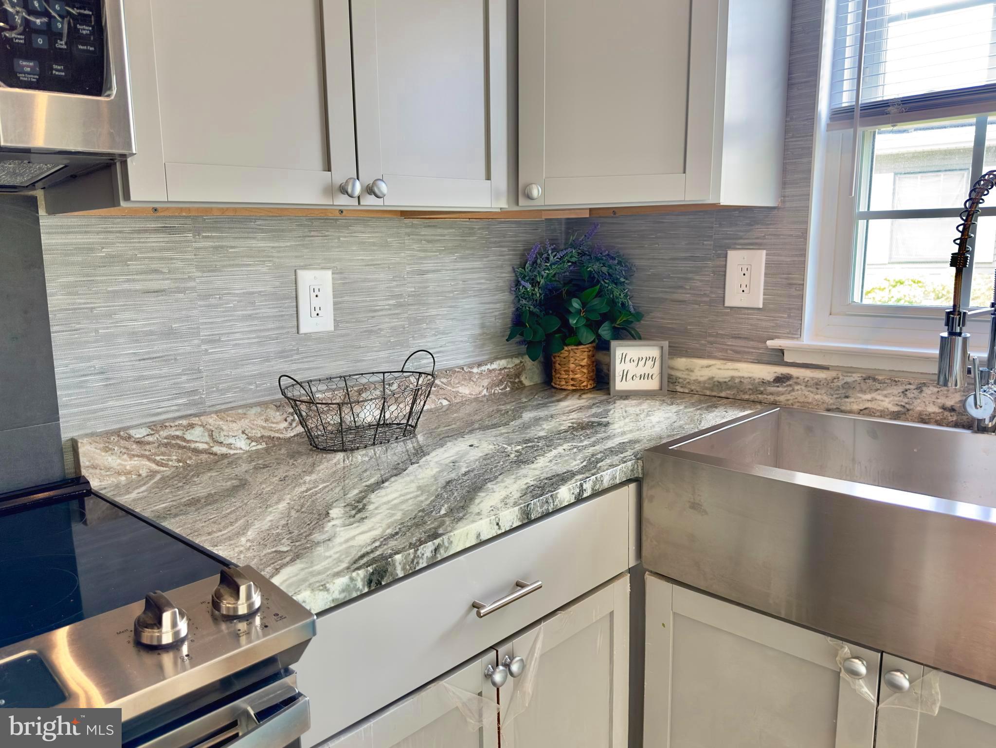 14 Narberth Place Southampton, NJ 08088 - Photo 12 of 33 a kitchen with granite countertop a sink a stove and cabinets