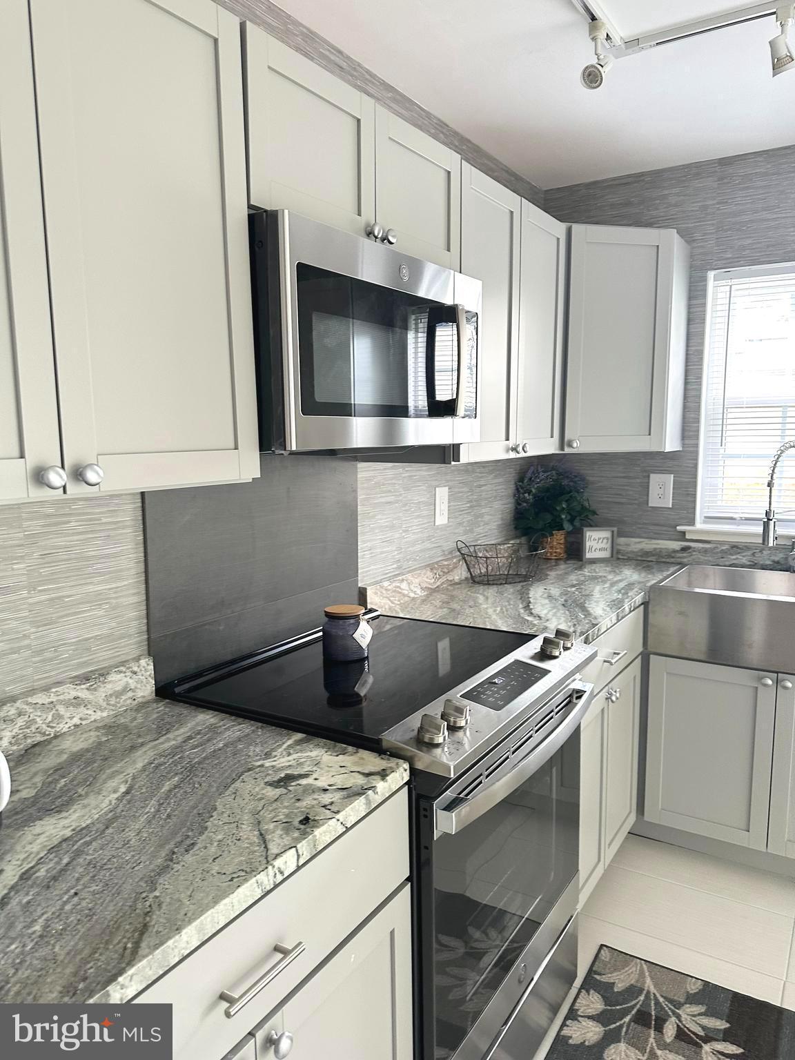 14 Narberth Place Southampton, NJ 08088 - Photo 15 of 33 a kitchen with granite countertop white cabinets and a stove