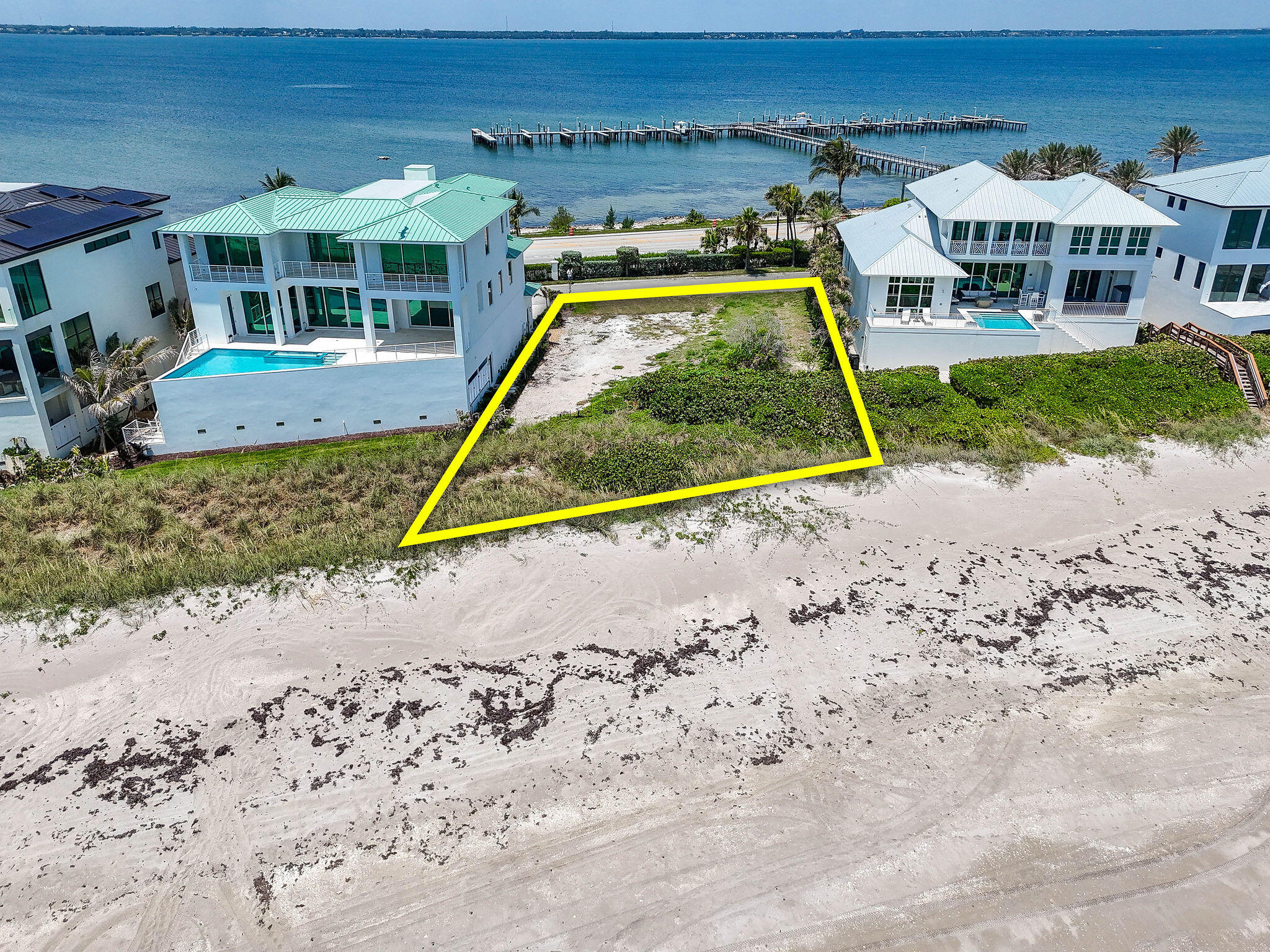 8128 South Ocean Drive Jensen Beach, FL 34957 - Photo 21 of 26 a view of a house with a swimming pool and a yard