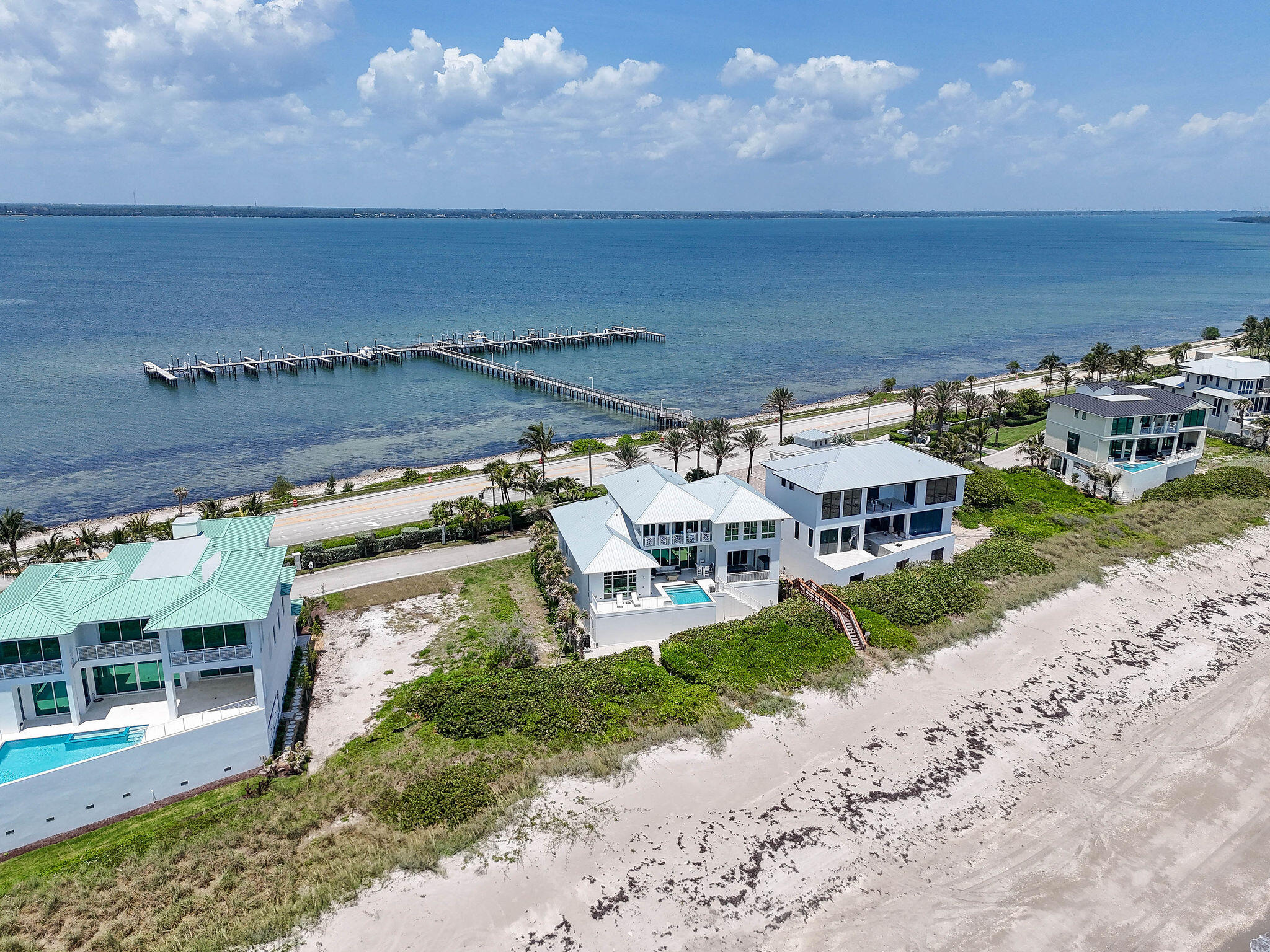 8128 South Ocean Drive Jensen Beach, FL 34957 - Photo 5 of 26 an aerial view of a house with a garden and mountain view in back