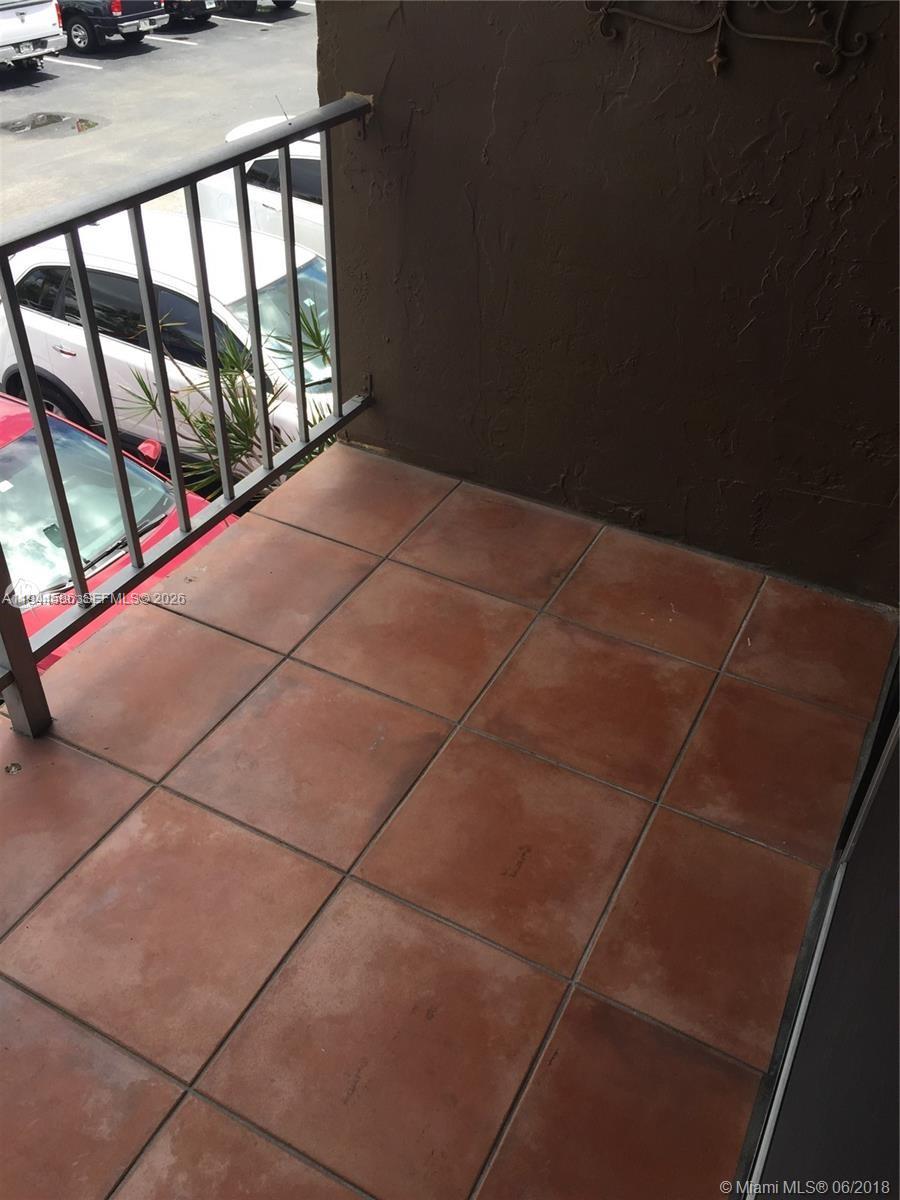 9403 Southwest 76th Street, Unit Y28 Miami, FL 33173 - Photo 17 of 20 a view of balcony and car parked