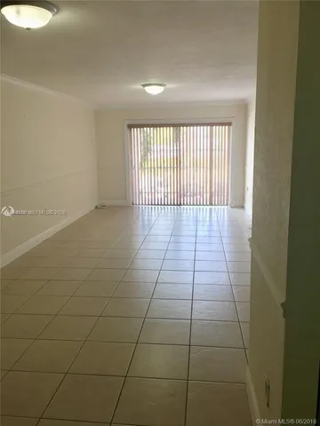 a view of an empty room and a window