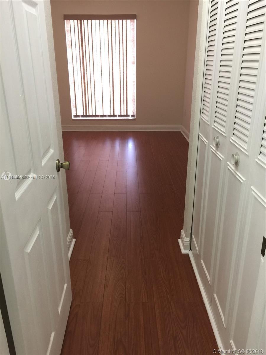9403 Southwest 76th Street, Unit Y28 Miami, FL 33173 - Photo 10 of 20 wooden floor in a gallery next to a window