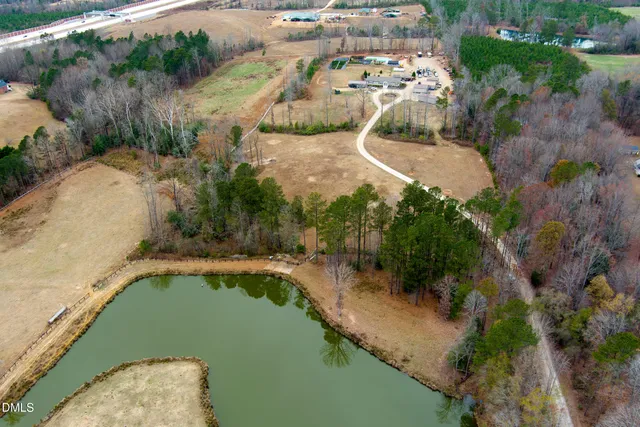 an aerial view of a house with a yard and lake view