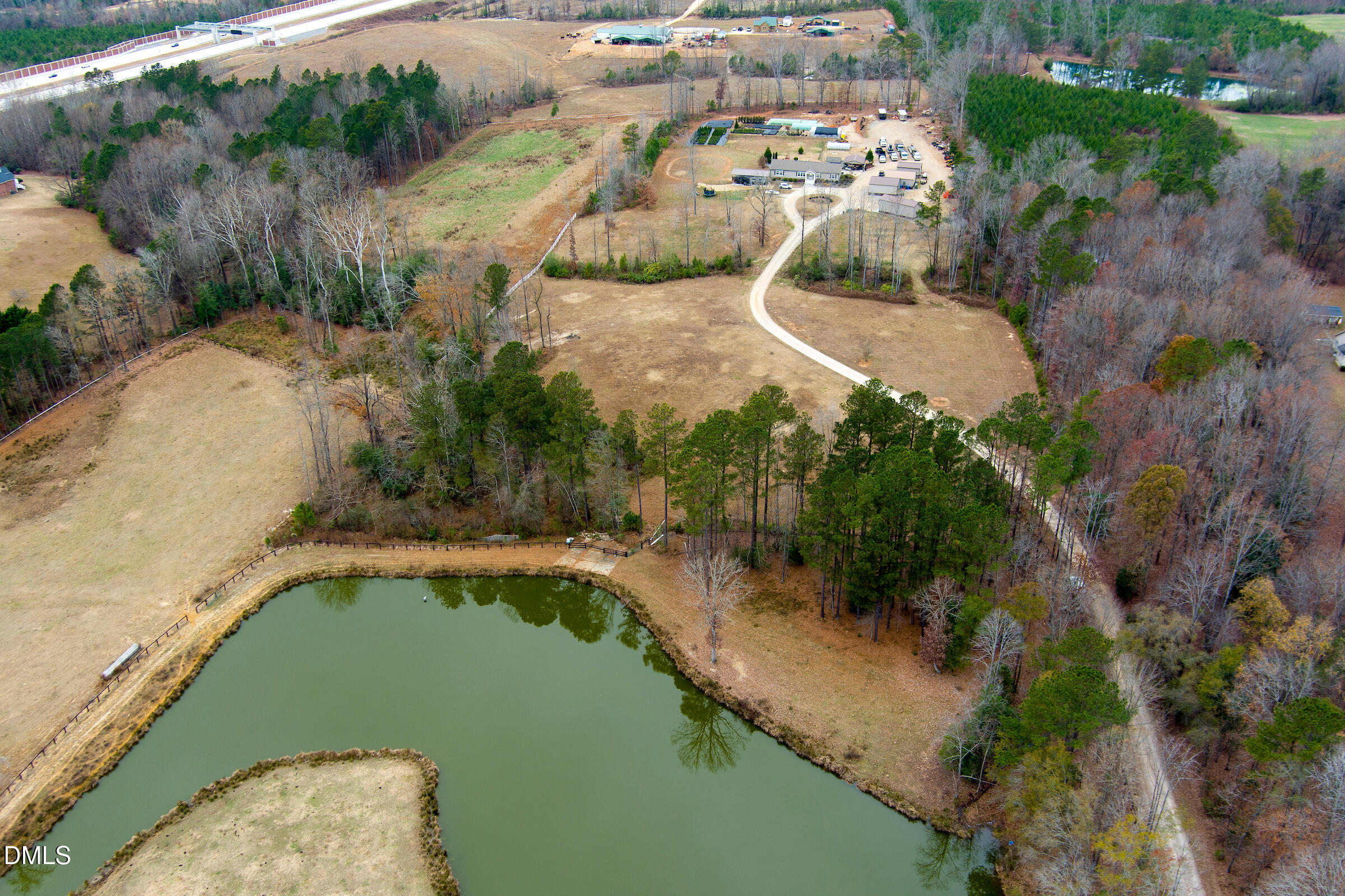 an aerial view of a house with a yard and lake view