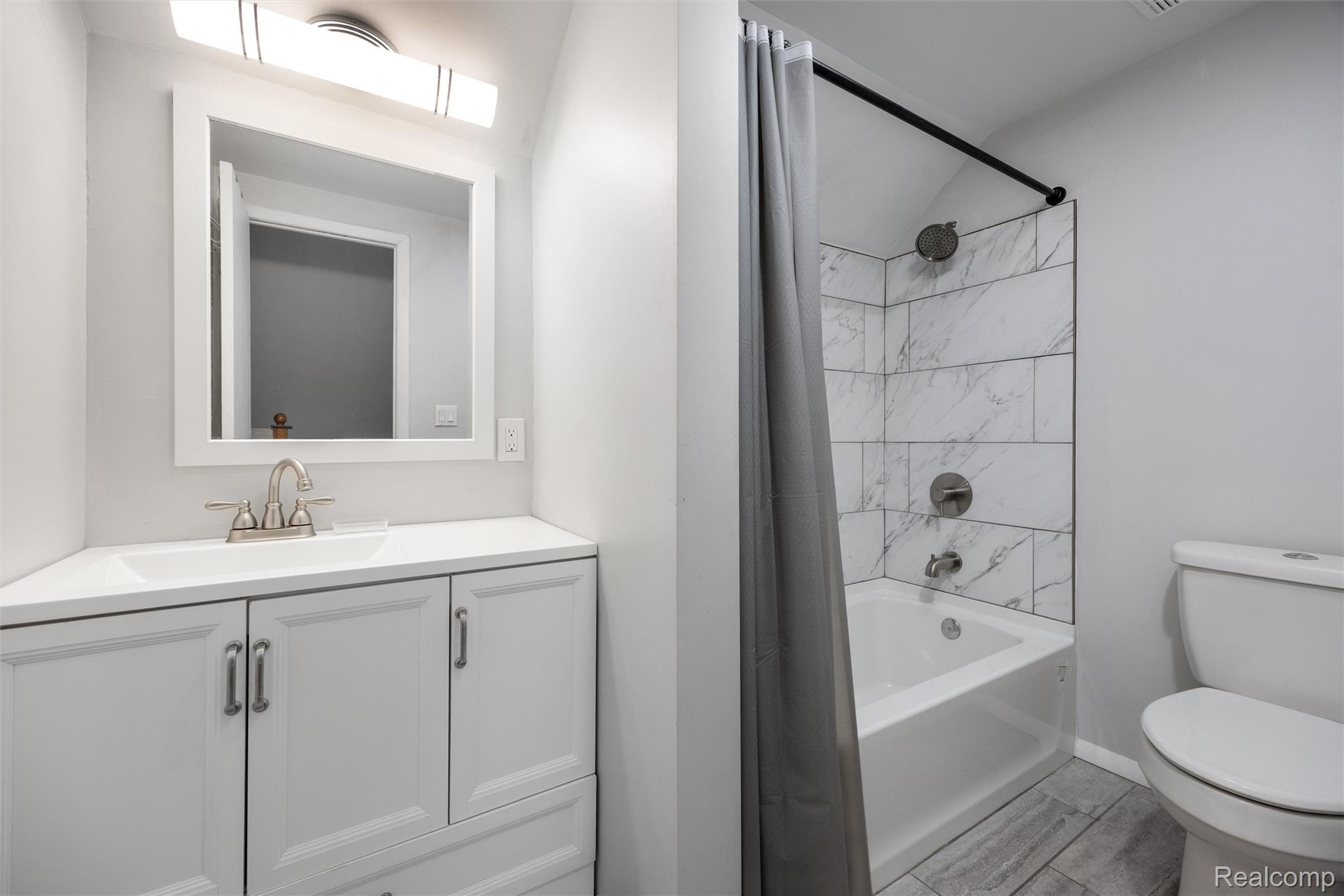 4942 Butler Drive Troy, MI 48085 - Photo 26 of 33 Bathroom with white vanity, integrated sink, and brushed nickel fixtures
