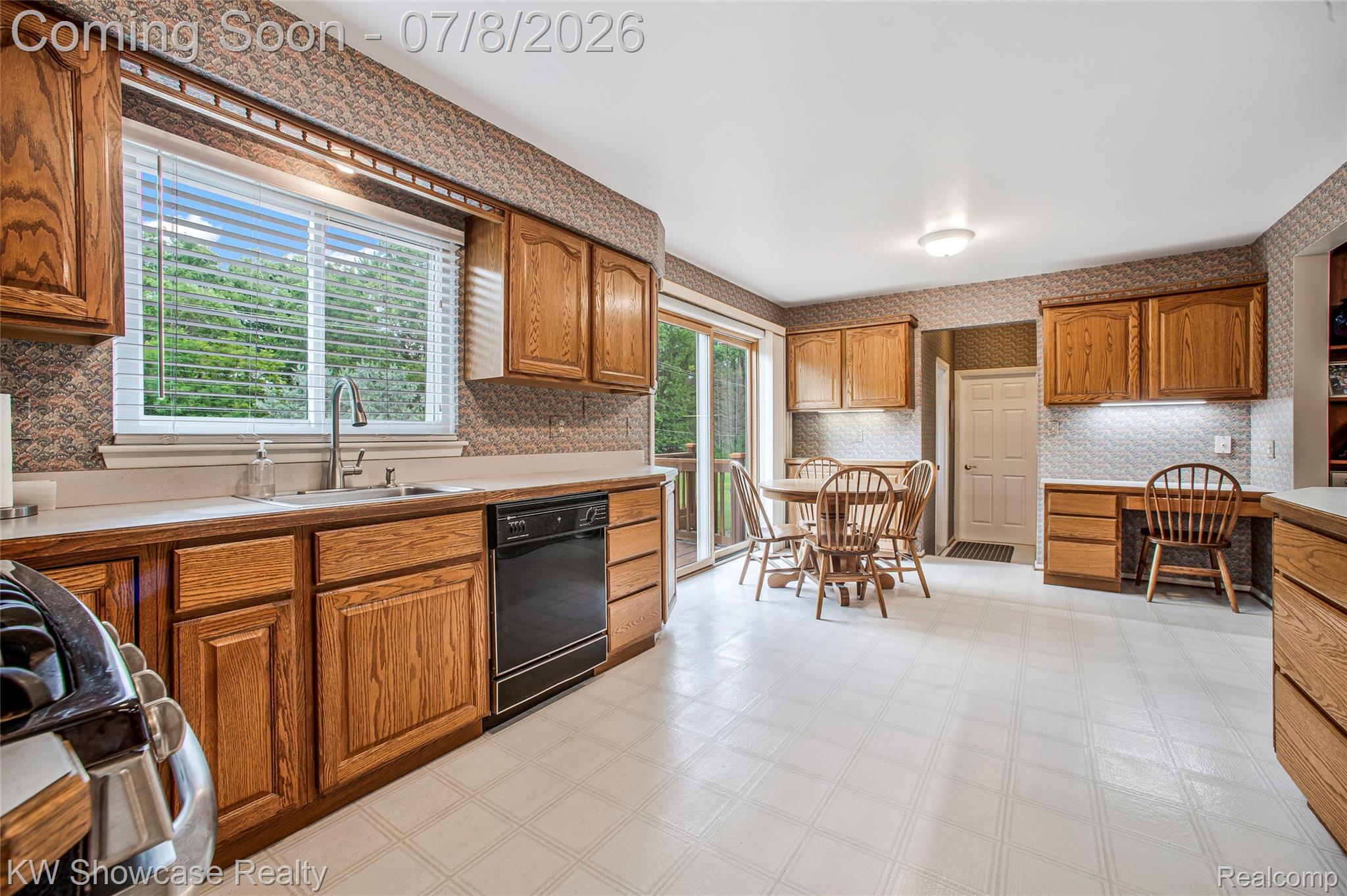 16720 Wayne Road Livonia, MI 48154 - Photo 11 of 29 Kitchen featuring wood-finish cabinetry, light-toned countertops, and a built-in black dishwasher