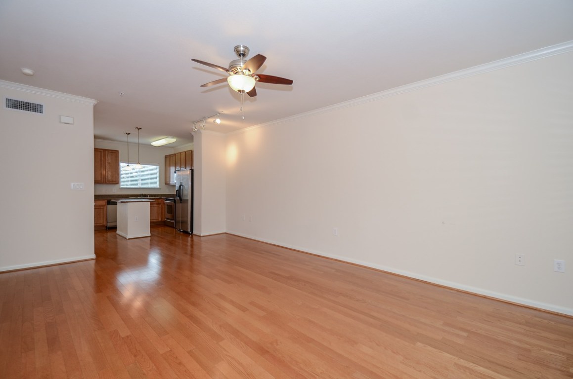 9200 Westheimer Road, Unit 802 Houston, TX 77063 - Photo 15 of 32 a view of a kitchen with a sink and dishwasher a refrigerator with wooden floor