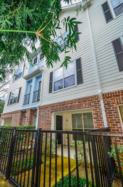 9200 Westheimer Road, Unit 802 Houston, TX 77063 - Photo 2 of 32 a front view of a house with a garden