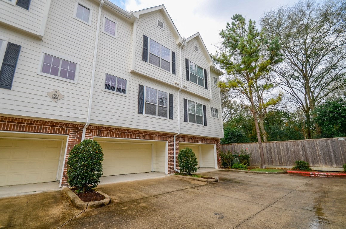 9200 Westheimer Road, Unit 802 Houston, TX 77063 - Photo 26 of 32 a view of a house with a yard and garage