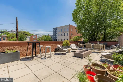 a view of roof deck with patio