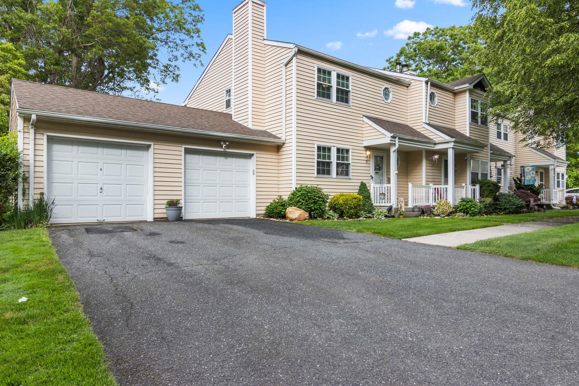 a view of a house with a yard and garage