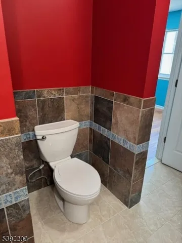a white toilet sitting next to a shower