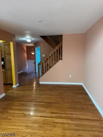 a view of a room with wooden floor