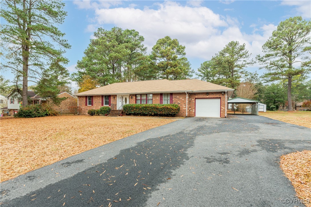 Showing long paved driveway and 2-Car Carport