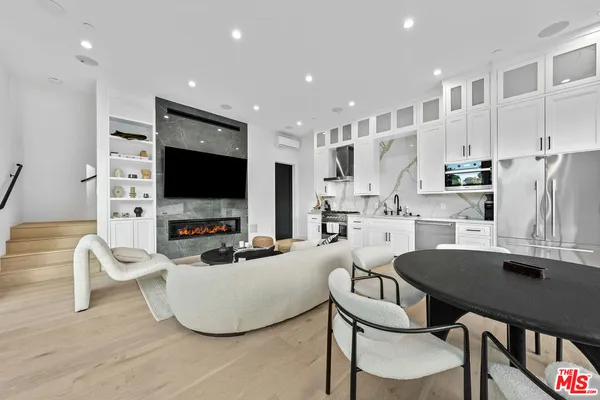 a bed room with furniture fireplace and a flat screen tv