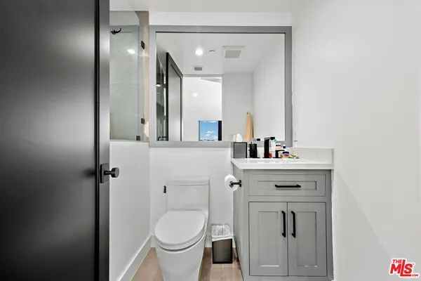 a bedroom with a bed and a ceiling fan