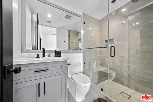 a bedroom with a large bed and a large window