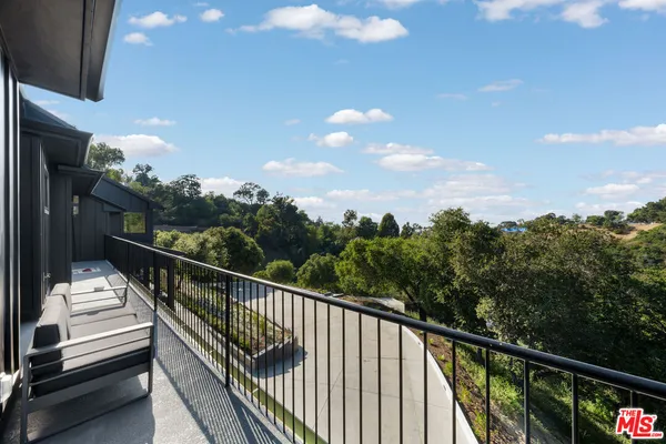 a aerial view of a house with swimming pool and a yard
