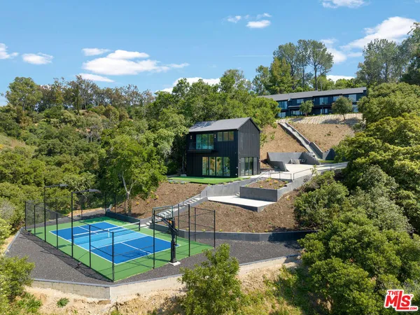 an aerial view of a house with a yard