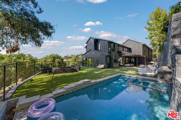 an aerial view of a house with a yard and outdoor seating