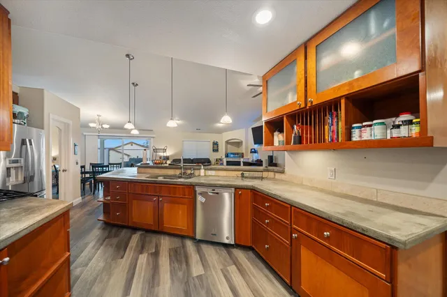 a large kitchen with stainless steel appliances kitchen island granite countertop a stove a sink and a refrigerator