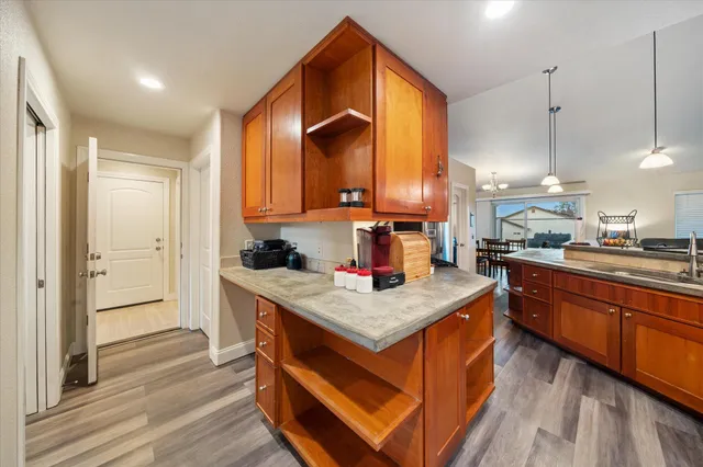a kitchen with stainless steel appliances granite countertop a stove a sink and a refrigerator