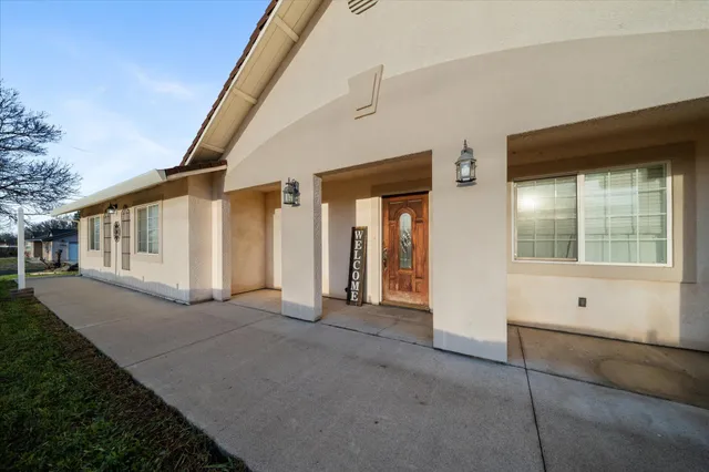 a view of an entrance to house with yard