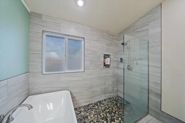 a bedroom with bed and a chandelier fan