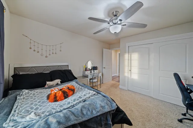 a bedroom with a bed and a desk in it