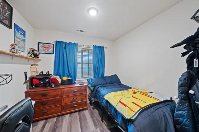 a bedroom with furniture and a window