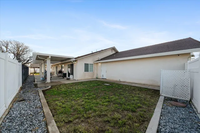 a view of backyard with wooden fence