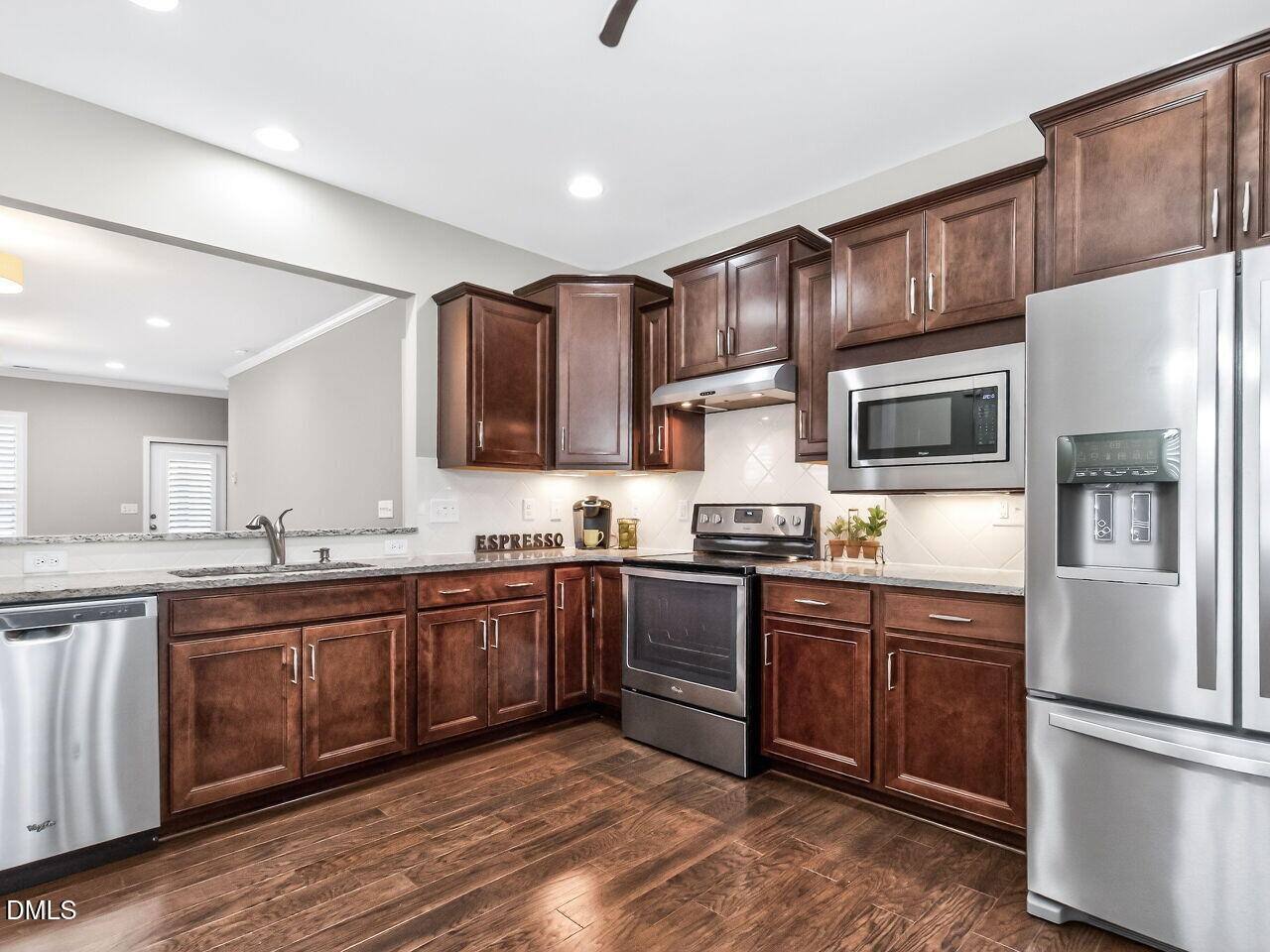 123 Merganser Way Durham, NC 27703 - Photo 13 of 37 a kitchen with stainless steel appliances granite countertop wooden cabinets a sink a stove a refrigerator and island with wooden floor