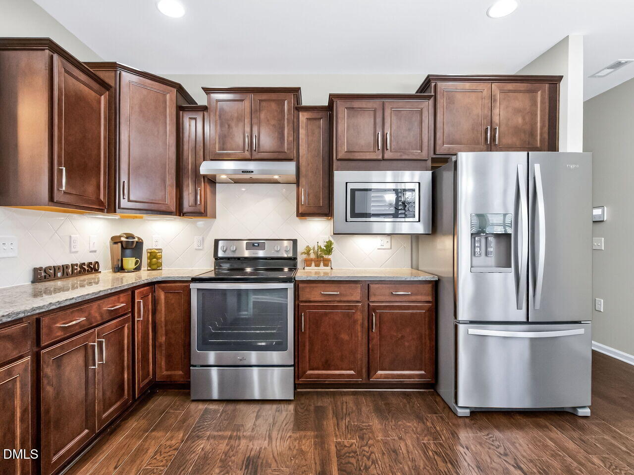 123 Merganser Way Durham, NC 27703 - Photo 15 of 37 a kitchen with stainless steel appliances granite countertop a refrigerator stove and sink with wooden cabinets