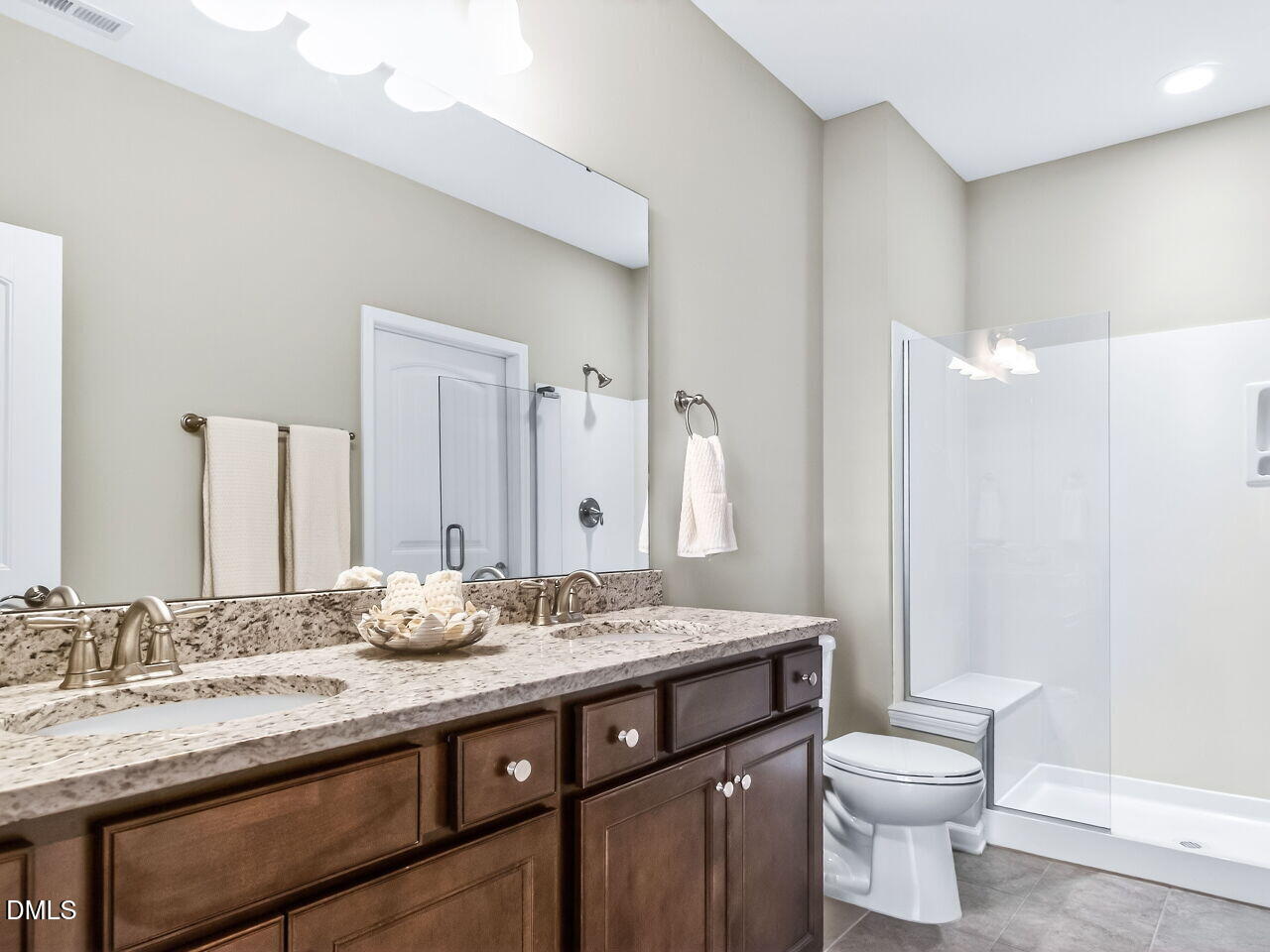 123 Merganser Way Durham, NC 27703 - Photo 19 of 37 a bathroom with a granite countertop sink a toilet and a mirror