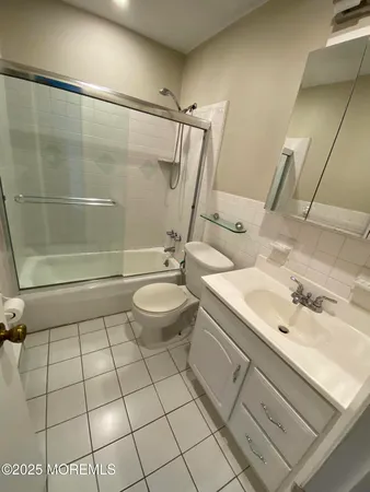 a bathroom with a sink toilet and mirror