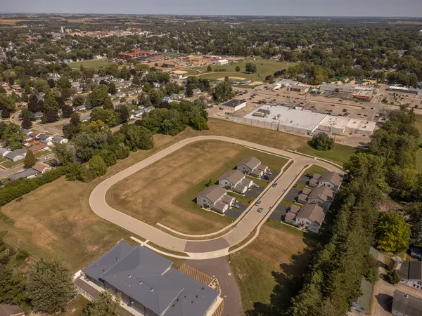 an aerial view of a residential houses with outdoor space