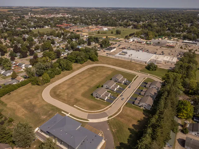 an aerial view of a residential houses with outdoor space