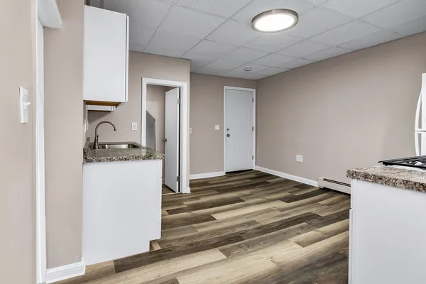 a bedroom with a bed and a stove