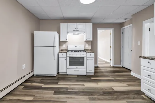 a kitchen with a stove and a refrigerator